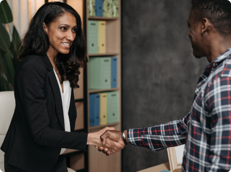 Smiling woman shaking man's hand
